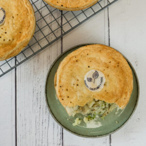 Broccoli, cauliflower and cheese pie on a green plate.