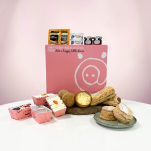 Our Classic Afternoon Tea for Two spread out next to our signature pink box.