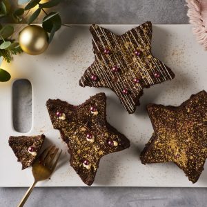 star shaped browis with fork and a bite taken out on a white board with gold baubles